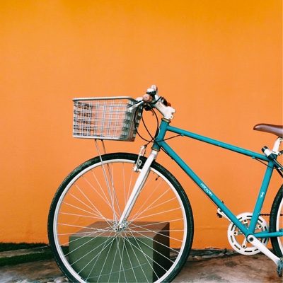 bycicle leaning against an orange wall.