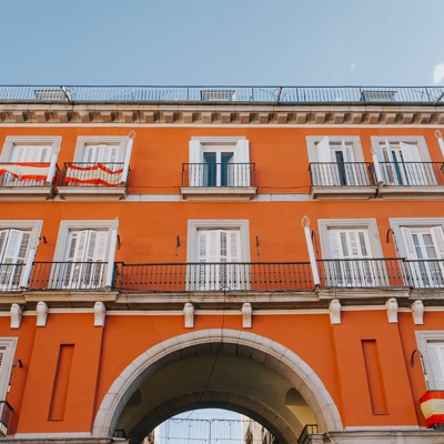 apartment building with an arched walkway leading to the street.