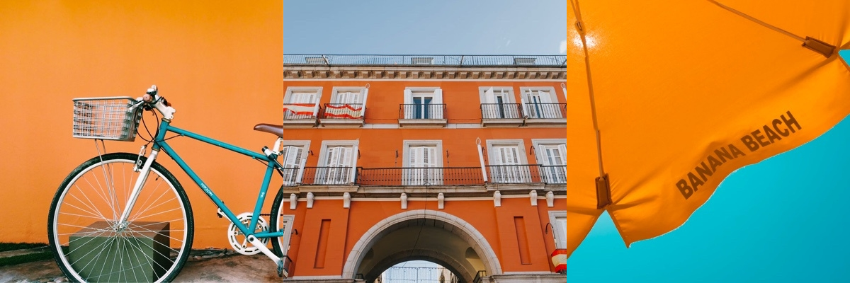 bycicle leaning against an orange wall. apartment building with an arched walkway leading to the street. Umbrella top with the words Banana Beach written on it.