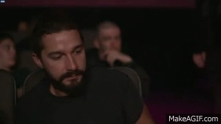 Shia looking very dissapointed in a movie theatre.